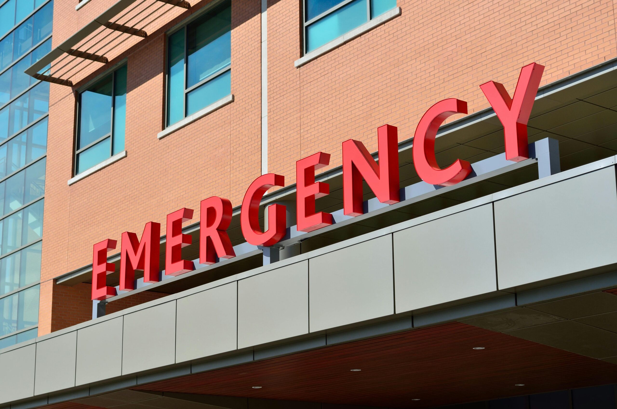 a-red-signage-that-reads-emergency-in-bold-letters